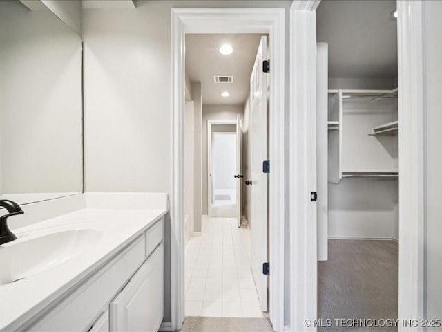 408 W Fairway Ct, Broken Arrow, OK 74011 - bathroom with vanity, tile patterned floors, a spacious closet, and recessed lighting