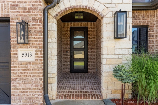 5913 E 127th St S, Tulsa, OK 74008 - doorway to property with stone siding and brick siding