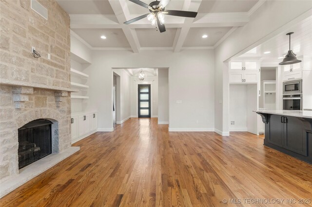 5913 E 127th St S, Tulsa, OK 74008 - unfurnished living room with coffered ceiling, a ceiling fan, a stone fireplace, light wood-style flooring, and beamed ceiling