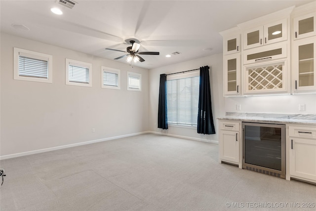 5913 E 127th St S, Tulsa, OK 74008 - kitchen featuring wine cooler, light carpet, a ceiling fan, white cabinets, and recessed lighting