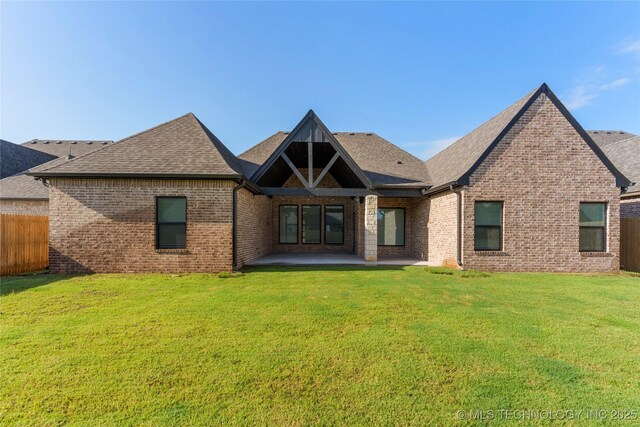 5913 E 127th St S, Tulsa, OK 74008 - back of house featuring brick siding, a patio area, and a shingled roof