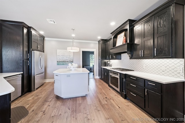 27920 160th St, Coweta, OK 74429 - kitchen featuring stainless steel appliances, a center island, light countertops, ornamental molding, and recessed lighting