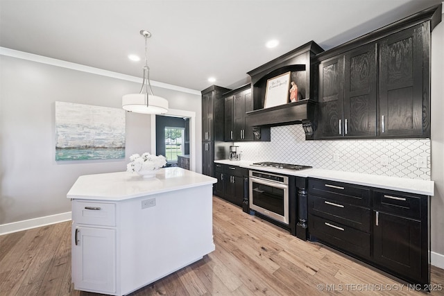 27920 160th St, Coweta, OK 74429 - kitchen with appliances with stainless steel finishes, dark cabinets, crown molding, tasteful backsplash, and light countertops