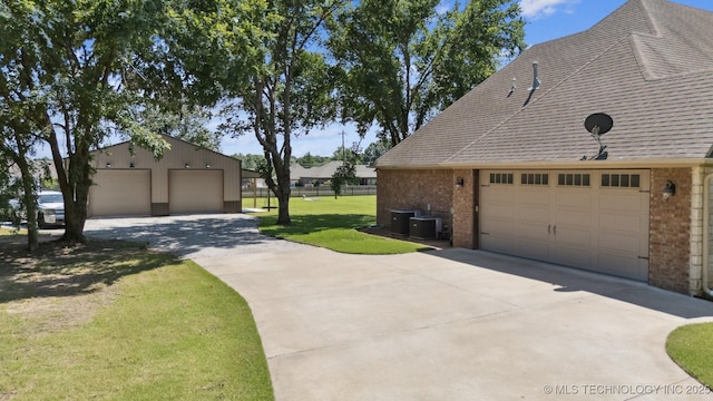 27920 160th St, Coweta, OK 74429 - view of side of home with brick siding, a lawn, an outbuilding, and a garage