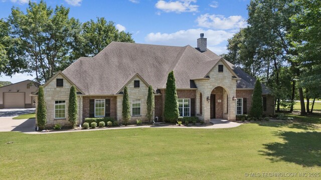 27920 160th St, Coweta, OK 74429 - french country inspired facade with stone siding, a chimney, and a front lawn