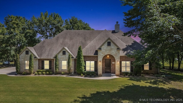 27920 160th St, Coweta, OK 74429 - french country home with stone siding, a chimney, and a front yard