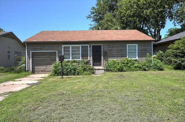 217 E 38th Pl, Tulsa, OK 74105 - single story home with concrete driveway, a front yard, and a garage