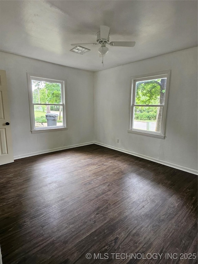 306 G St SE, Ardmore, OK 73401 - empty room featuring plenty of natural light, dark wood-type flooring, and ceiling fan