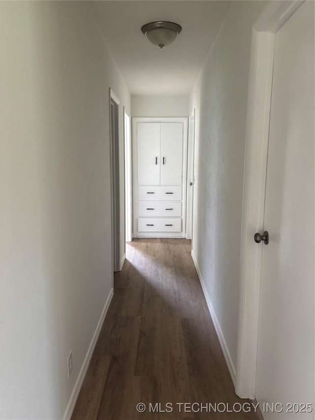 18969 County Road 3560, Ada, OK 74820 - hallway featuring dark wood-style flooring and baseboards