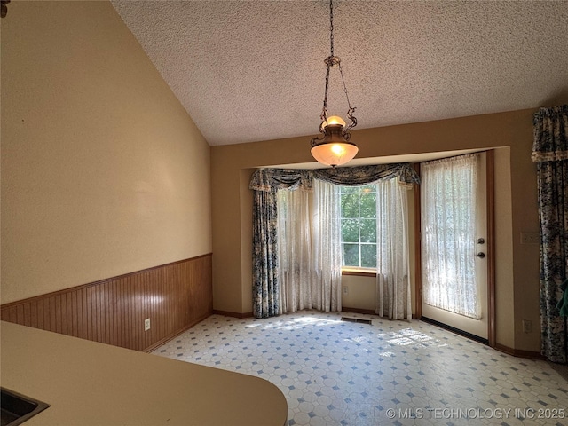 4525 Summit Pl, Sand Springs, OK 74063 - unfurnished dining area with a textured ceiling, vaulted ceiling, and carpet floors