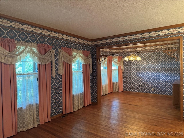 4525 Summit Pl, Sand Springs, OK 74063 - empty room with wood-type flooring, a textured ceiling, ornamental molding, and plenty of natural light