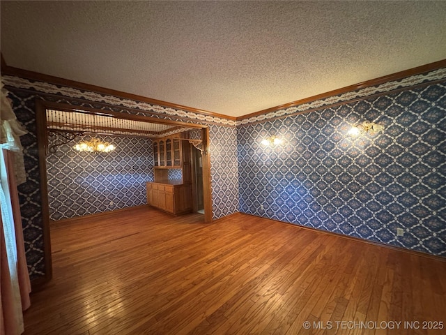 4525 Summit Pl, Sand Springs, OK 74063 - unfurnished room with crown molding, light wood-style flooring, a textured ceiling, and wallpapered walls