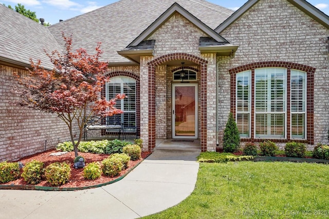 1005 E Fargo St, Broken Arrow, OK 74012 - property entrance with brick siding, a shingled roof, and a yard