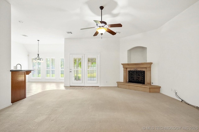 1005 E Fargo St, Broken Arrow, OK 74012 - unfurnished living room with carpet flooring, a fireplace with raised hearth, a ceiling fan, and a chandelier