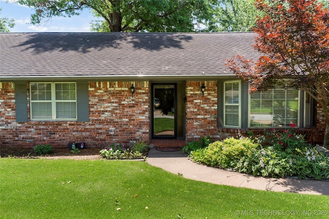 6016 E 52nd Pl, Tulsa, OK 74135 - view of front of house featuring a shingled roof, brick siding, and a front yard