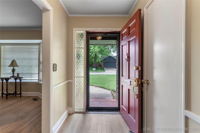 6016 E 52nd Pl, Tulsa, OK 74135 - entrance foyer featuring light wood-type flooring, healthy amount of natural light, and crown molding