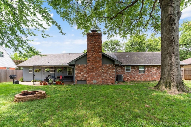 6016 E 52nd Pl, Tulsa, OK 74135 - rear view of property featuring a fire pit, a chimney, a patio, roof with shingles, and brick siding