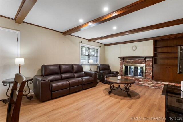 6016 E 52nd Pl, Tulsa, OK 74135 - living area with beam ceiling, wood finished floors, and a fireplace