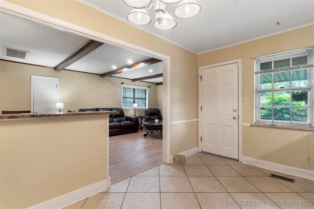 6016 E 52nd Pl, Tulsa, OK 74135 - foyer with crown molding, light tile patterned floors, and a chandelier