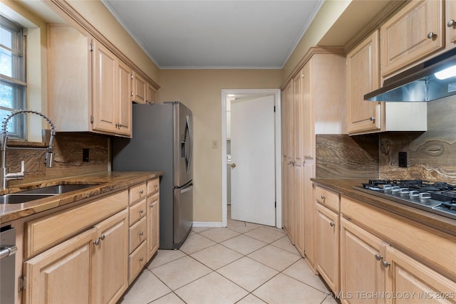 6016 E 52nd Pl, Tulsa, OK 74135 - kitchen with light brown cabinetry, stainless steel appliances, ornamental molding, light tile patterned flooring, and under cabinet range hood