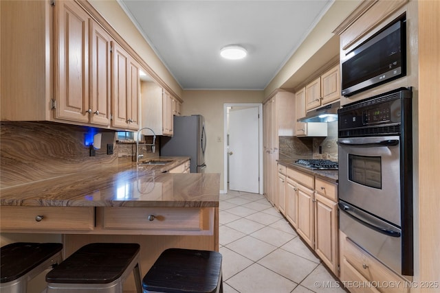 6016 E 52nd Pl, Tulsa, OK 74135 - kitchen featuring appliances with stainless steel finishes, a warming drawer, under cabinet range hood, a peninsula, and a breakfast bar