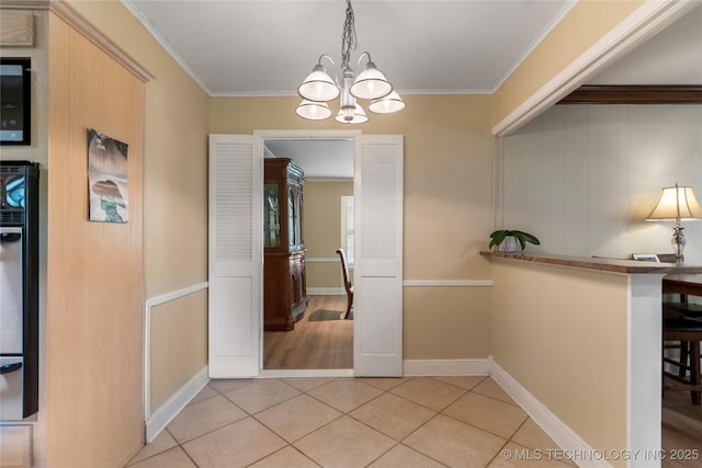 6016 E 52nd Pl, Tulsa, OK 74135 - hallway with a chandelier, crown molding, and light tile patterned floors