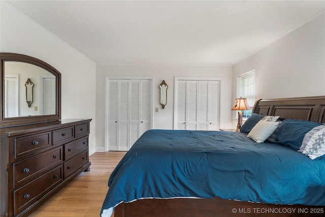 6016 E 52nd Pl, Tulsa, OK 74135 - bedroom with multiple closets, light wood-style floors, and ornamental molding