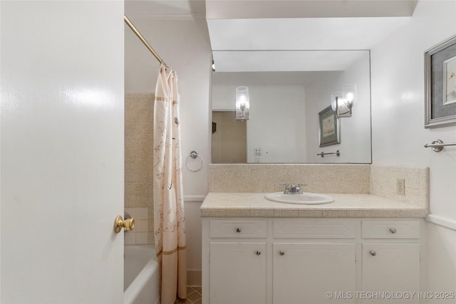 6016 E 52nd Pl, Tulsa, OK 74135 - full bathroom with vanity, shower / bath combo with shower curtain, decorative backsplash, and tile patterned flooring