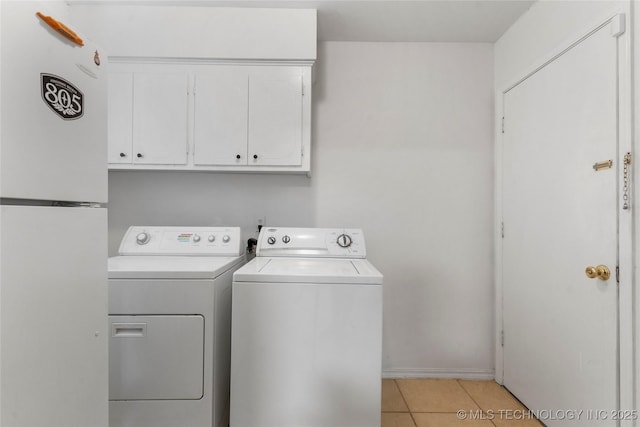 6016 E 52nd Pl, Tulsa, OK 74135 - washroom featuring cabinet space, washer and clothes dryer, and light tile patterned floors
