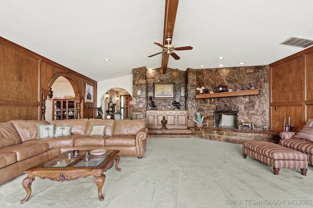 17331 S 174th Ave E, Bixby, OK 74008 - carpeted living area featuring arched walkways, a ceiling fan, and a fireplace