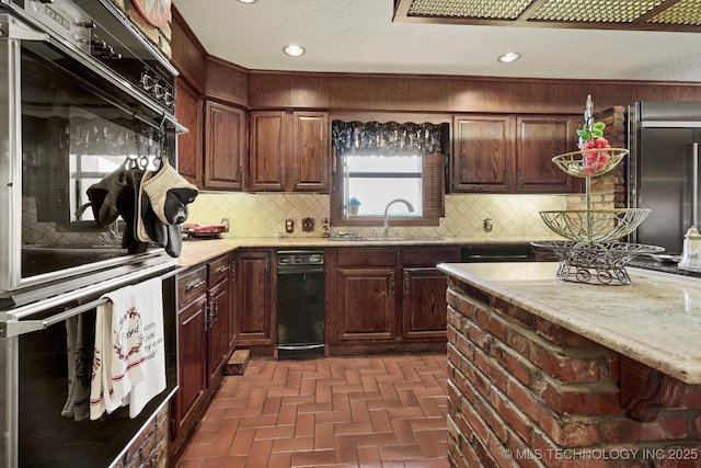 17331 S 174th Ave E, Bixby, OK 74008 - kitchen with tasteful backsplash, brick patterned floors, high quality fridge, recessed lighting, and light stone countertops