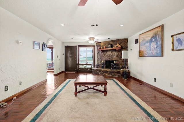 17331 S 174th Ave E, Bixby, OK 74008 - living room featuring ceiling fan, arched walkways, recessed lighting, and a fireplace