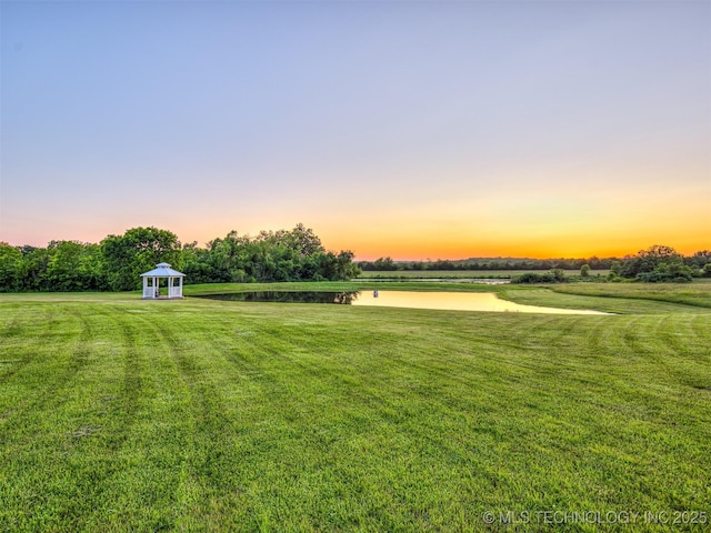 353800 E 5400th Rd, Maramec Twp, OK 74045 - yard at dusk with a water view and a lawn