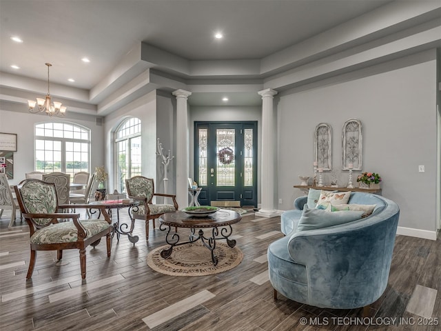 353800 E 5400th Rd, Maramec Twp, OK 74045 - living room with ornate columns, a raised ceiling, wood finished floors, recessed lighting, and a chandelier