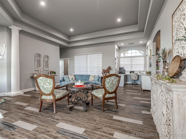 353800 E 5400th Rd, Maramec Twp, OK 74045 - living room featuring ornate columns, a tray ceiling, recessed lighting, wood finished floors, and arched walkways