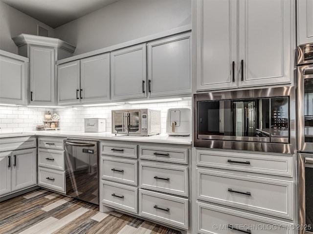 353800 E 5400th Rd, Maramec Twp, OK 74045 - kitchen with built in microwave, light countertops, backsplash, wood finished floors, and dishwasher