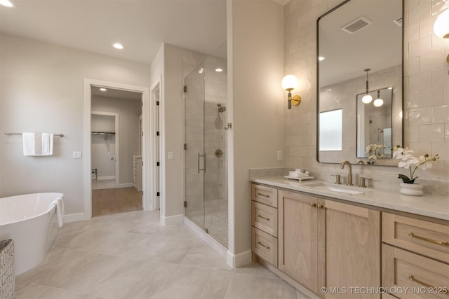 3528 S Troost Ave, Tulsa, OK 74105 - full bath with a shower stall, vanity, a freestanding tub, recessed lighting, and decorative backsplash