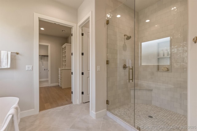 3528 S Troost Ave, Tulsa, OK 74105 - full bath with a stall shower, tile patterned flooring, a freestanding bath, a spacious closet, and recessed lighting