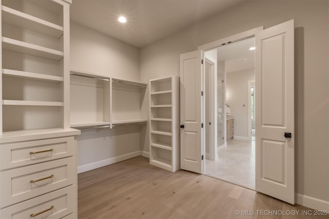 3528 S Troost Ave, Tulsa, OK 74105 - walk in closet with light wood-style floors