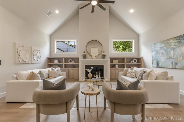 3528 S Troost Ave, Tulsa, OK 74105 - living room featuring high vaulted ceiling, wood finished floors, ceiling fan, recessed lighting, and a fireplace with raised hearth