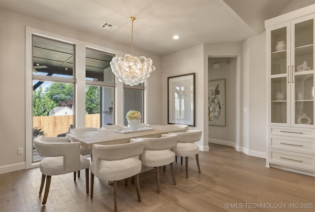 3528 S Troost Ave, Tulsa, OK 74105 - dining space with light wood-style floors, a chandelier, and recessed lighting
