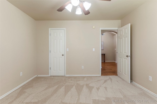 11936 S 98th E Ave, Bixby, OK 74008 - unfurnished bedroom featuring arched walkways, carpet floors, and ceiling fan