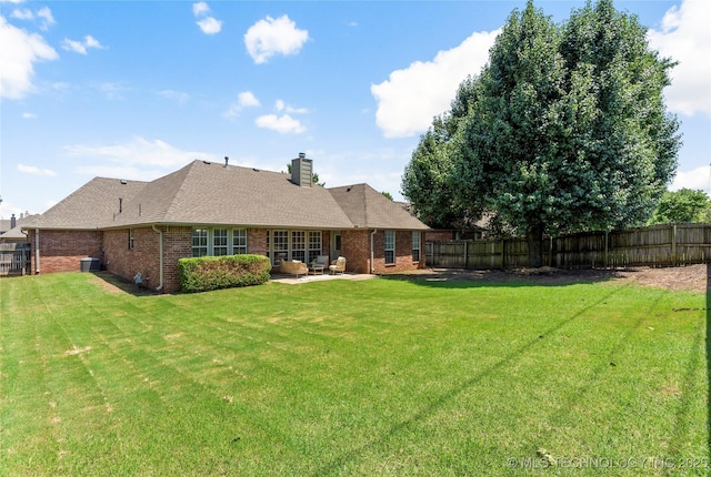11936 S 98th E Ave, Bixby, OK 74008 - rear view of property with brick siding, a fenced backyard, a patio area, and a chimney