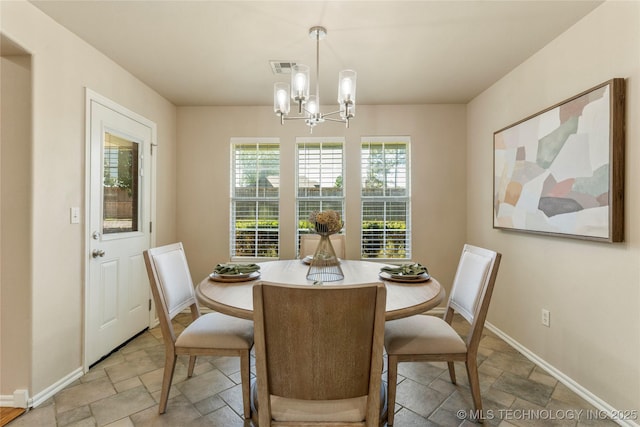 11936 S 98th E Ave, Bixby, OK 74008 - dining space with stone tile flooring and a chandelier