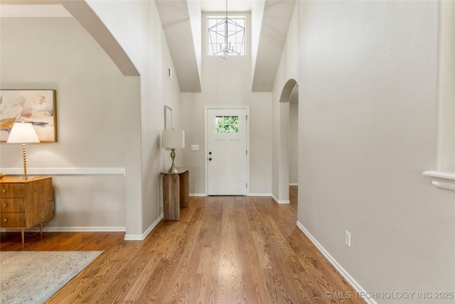 11936 S 98th E Ave, Bixby, OK 74008 - foyer featuring arched walkways, high vaulted ceiling, and wood finished floors
