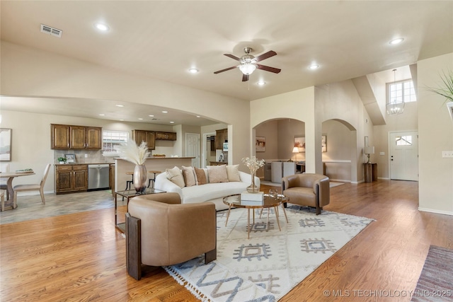11936 S 98th E Ave, Bixby, OK 74008 - living room with arched walkways, light wood-style flooring, recessed lighting, and a ceiling fan