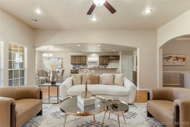 11936 S 98th E Ave, Bixby, OK 74008 - living area with arched walkways, ceiling fan, recessed lighting, light wood-type flooring, and healthy amount of natural light