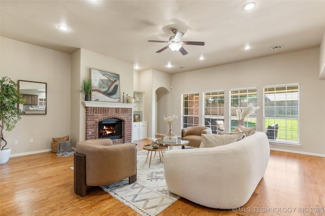 11936 S 98th E Ave, Bixby, OK 74008 - living room featuring recessed lighting, a brick fireplace, a ceiling fan, and light wood-style floors