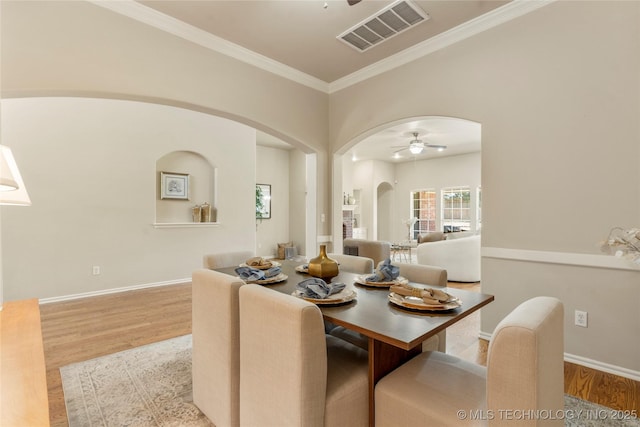 11936 S 98th E Ave, Bixby, OK 74008 - dining space with a ceiling fan, arched walkways, wood finished floors, and crown molding