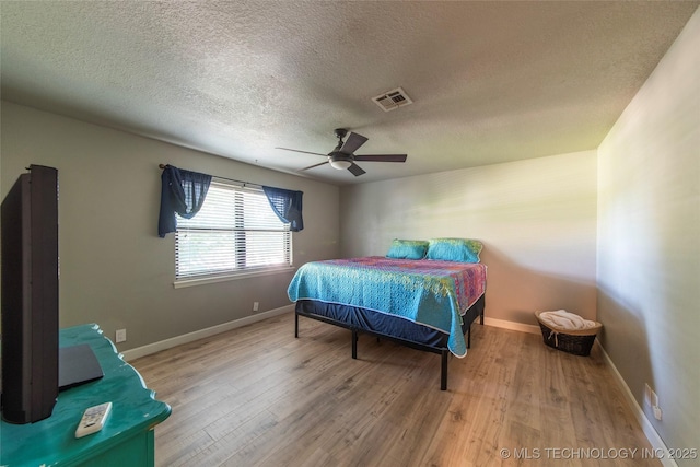 809 W Imperial St, Broken Arrow, OK 74011 - bedroom featuring wood finished floors, a textured ceiling, and ceiling fan